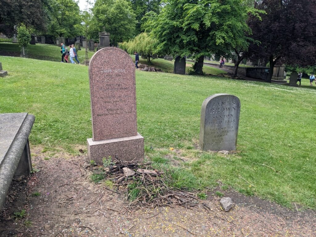 The grave on which Greyfriars Bobby is said to have sat for most of his life is now covered in sticks.